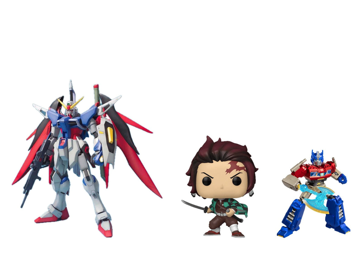 Bandai MG Destiny Gundam, Funko Pop! Tanjiro Kamado and a Blokees Galaxy Version Optimus Prime on white