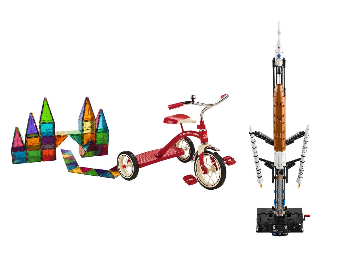 Magnetic tiles, a red tricycle and a LEGO Technic rocket on white