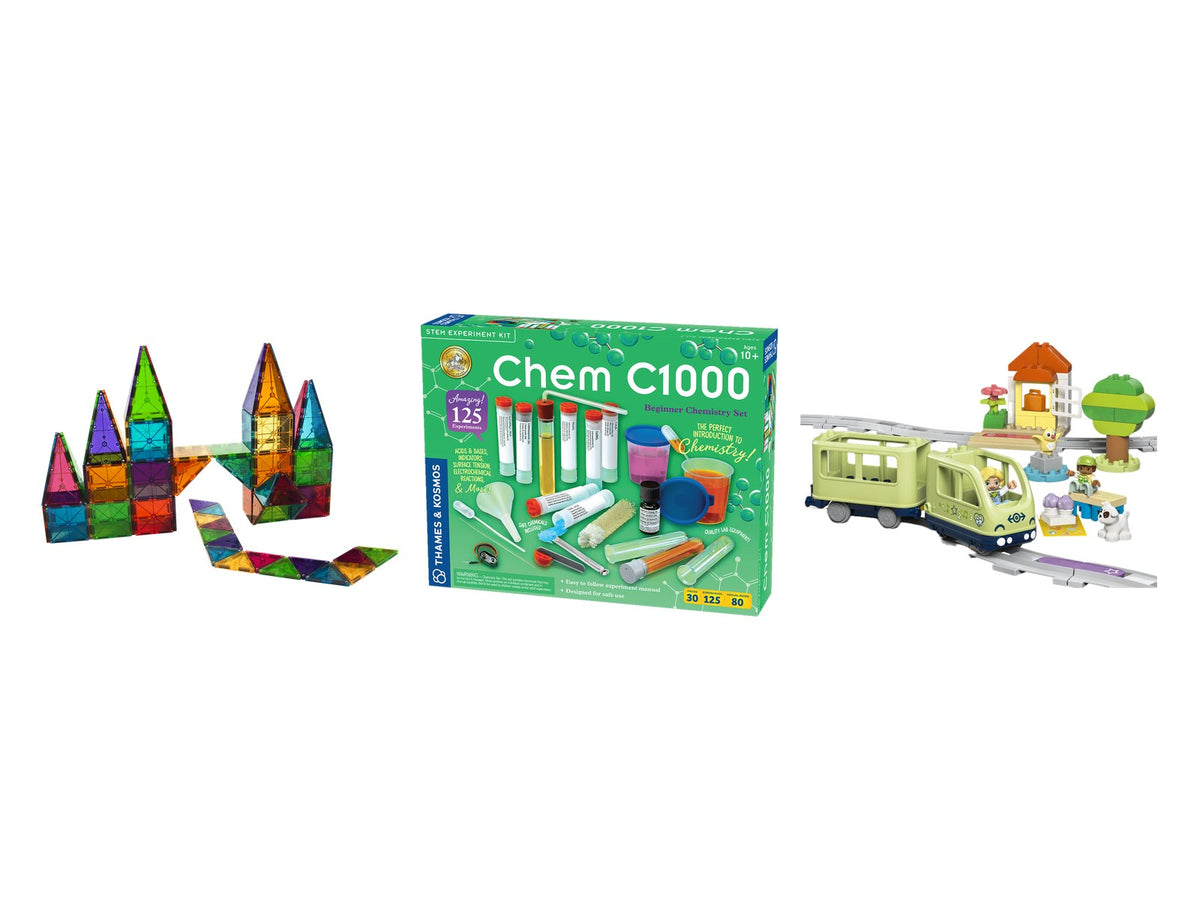 Magnetic tiles, a chemistry set, and a battery-powered toy train on white