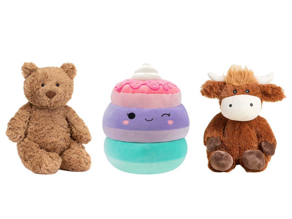 Jellycat Bartholomew Bear, a Squishmallows pancake stack and a Warmies Highland Cow on white